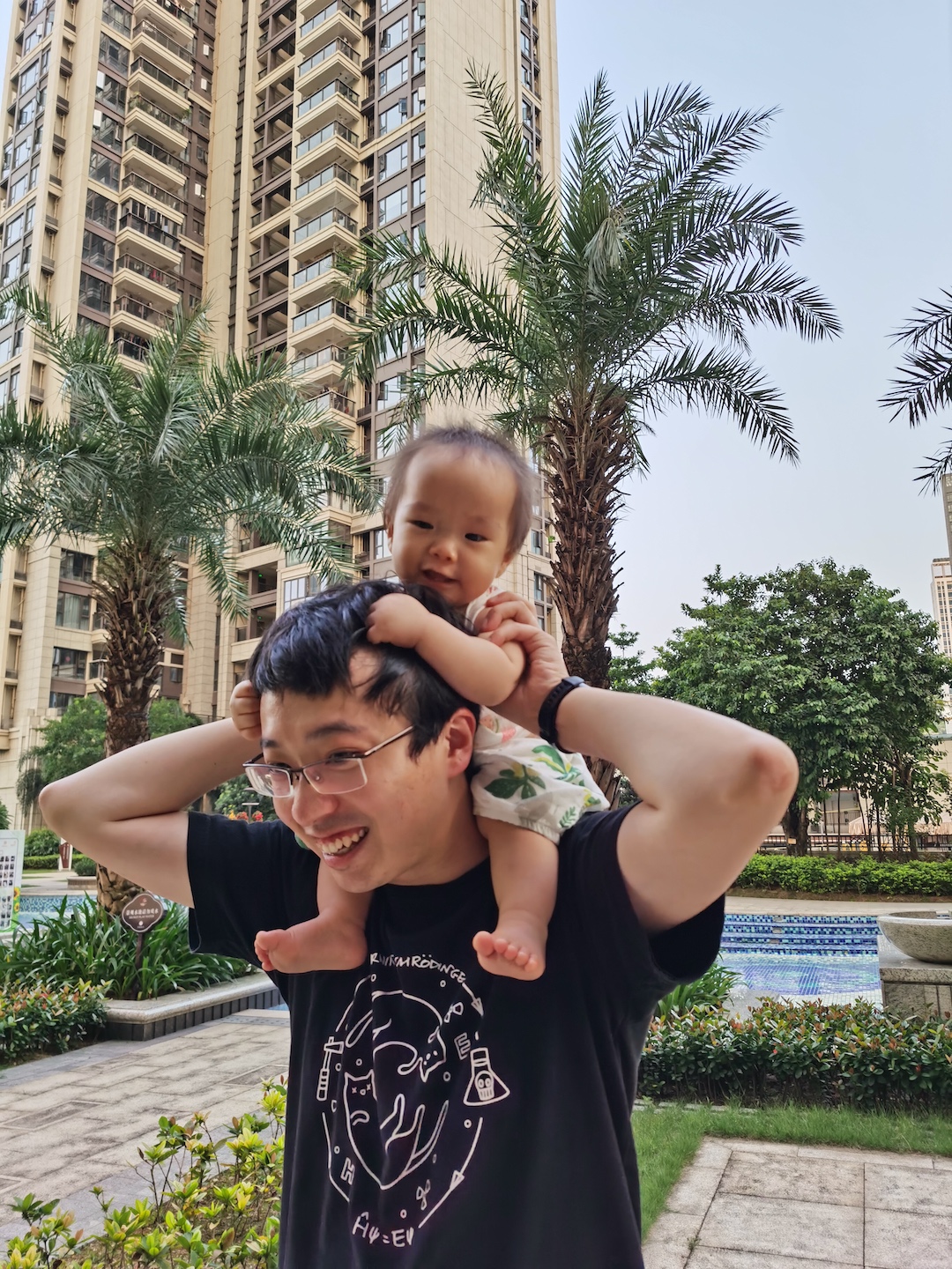Cocoa Bean is riding on Daddy's neck.